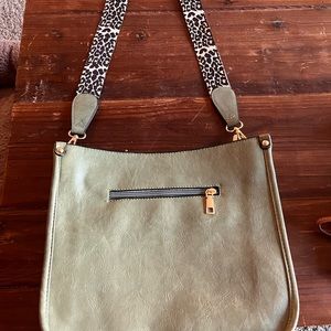 Never used crossbody leather bag.  Brand unknown.  Leopard polyester strap